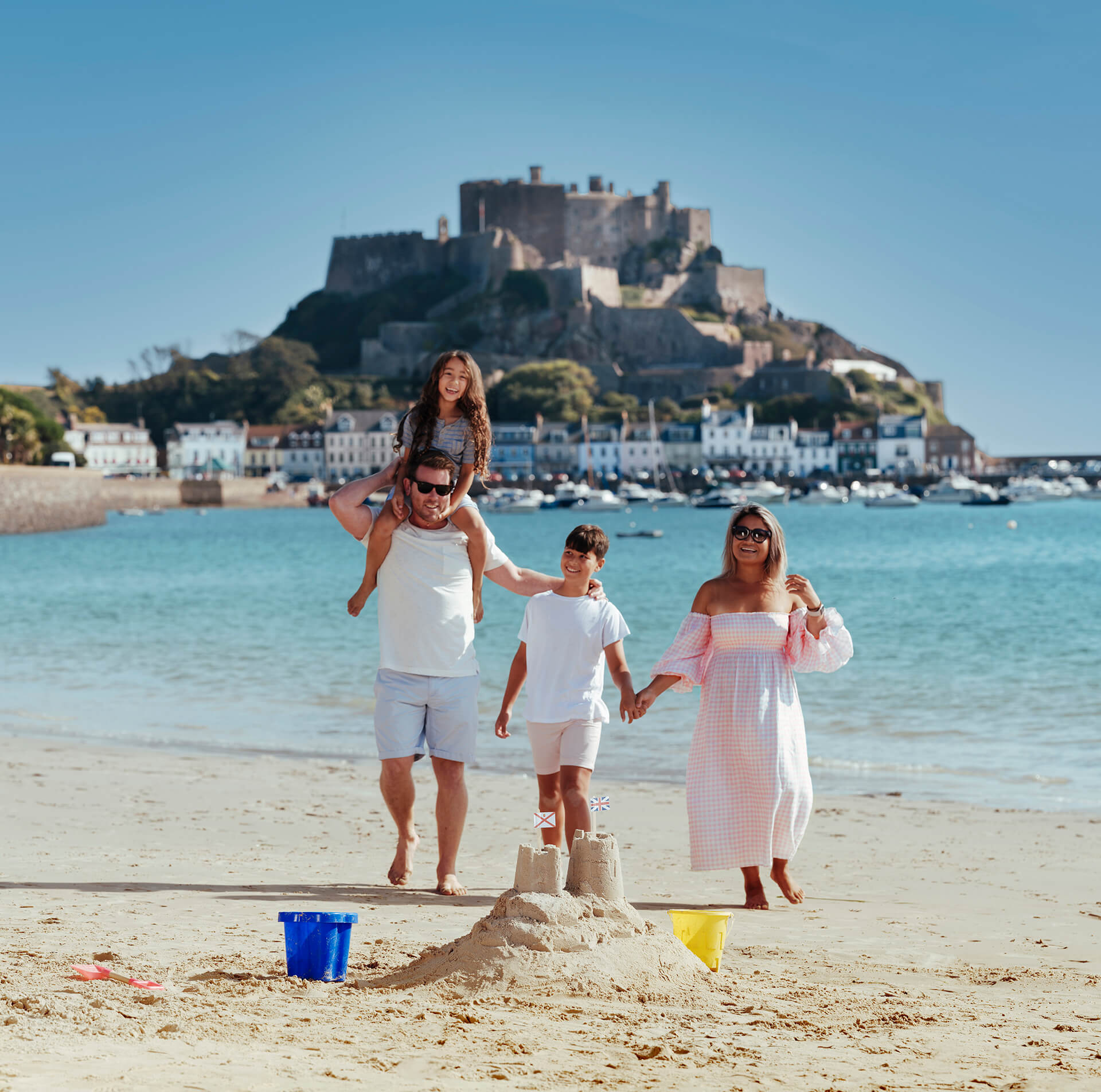 Family having fun near Mont Orgueil castle in Gorey, Jersey